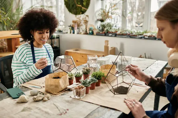 Friends enjoy a lively workshop where they create beautiful terrariums with succulents and plants. — Stock Photo