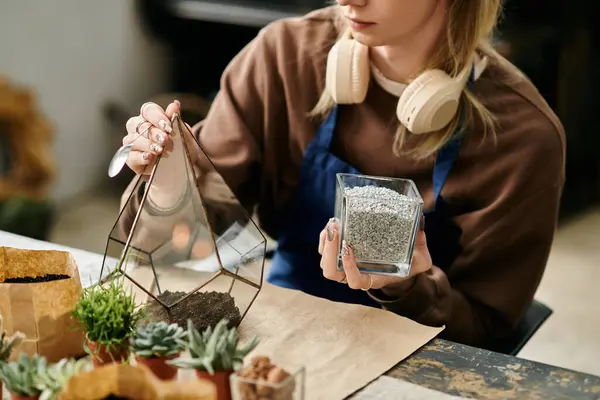 Hände sind damit beschäftigt, ein schönes Terrarium mit lebendigen Sukkulenten und Bodenmischung zusammenzustellen. — Stockfoto