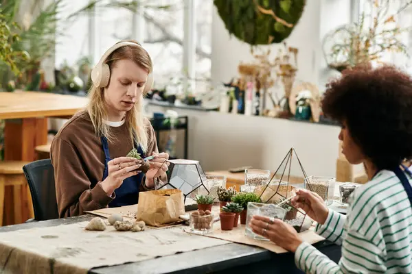 Participants engage in a hands on workshop, crafting unique succulent displays with joy. — Stock Photo
