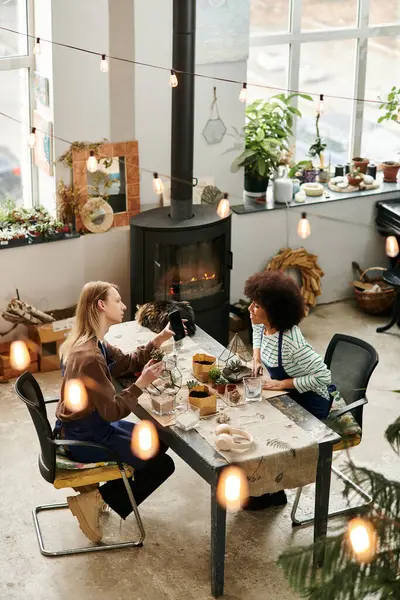 Two friends enjoy a plant workshop, crafting beautiful succulent arrangements together. — Stock Photo