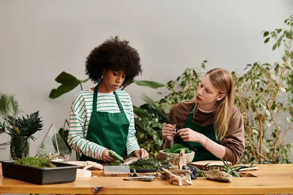 Two friends gather at a workshop to craft beautiful succulent arrangements surrounded by plants. — Stock Photo
