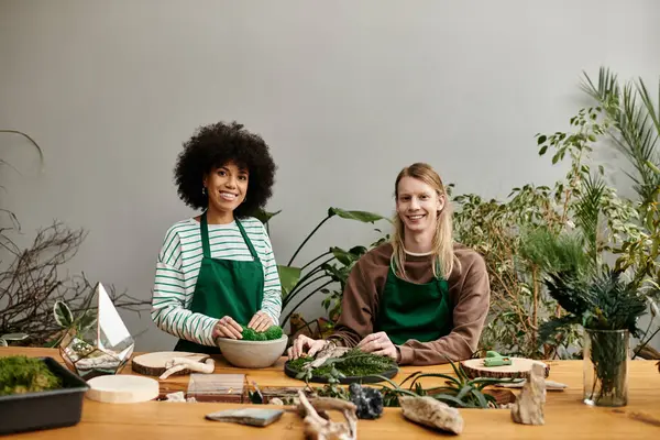 Two friends share smiles and creativity while crafting unique succulent arrangements in a workshop. — Stock Photo