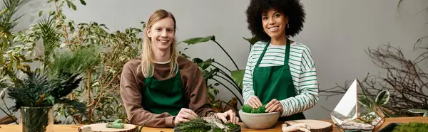 Two friends smile at a fun workshop on crafting with plants and succulents. — Stock Photo