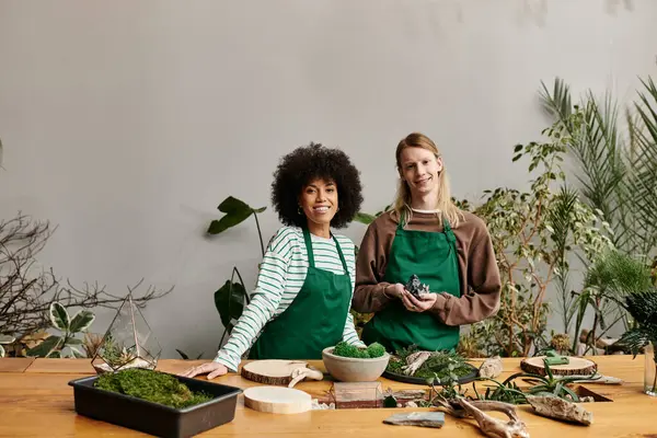 Two friends smile as they craft succulent arrangements during a fun plant workshop together. — Stock Photo