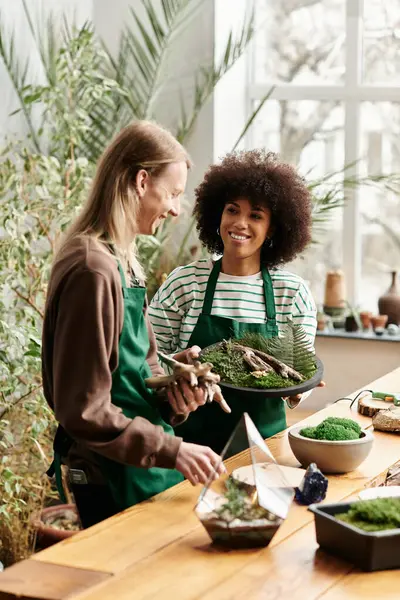 Participants joyfully craft with succulents in a lush green workshop. — Stock Photo