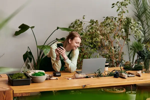 Good looking man working with his laptop in a vibrant green setting. — Stock Photo