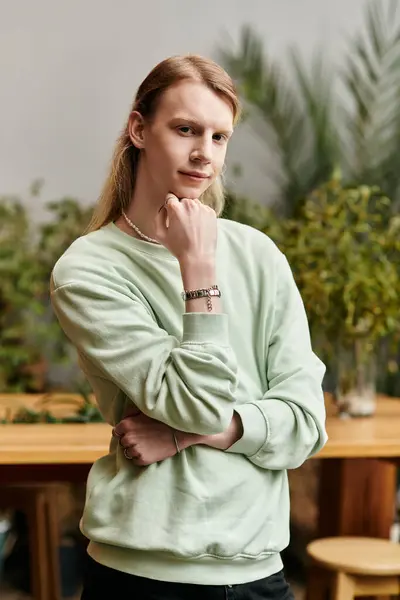 Attractive long haired man in stylish attire in workshop studio. — Stock Photo