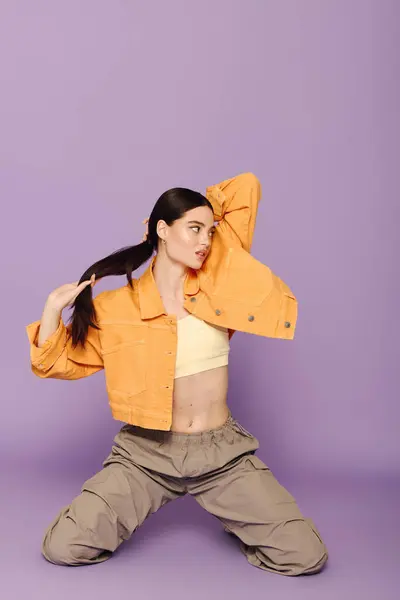 Fashionable young woman showcases her stylish look with a playful pose and vibrant colors — Stock Photo