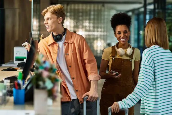 Group of colleagues check in at a stylish hotel while sharing smiles and travel stories. — Stock Photo