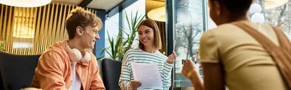Colleagues share laughter and ideas in a chic hotel lobby, enjoying their time together. — Stock Photo