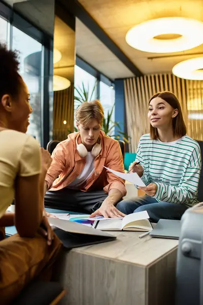 Three colleagues engage in a creative brainstorming session at a stylish hotel lounge. — Stock Photo