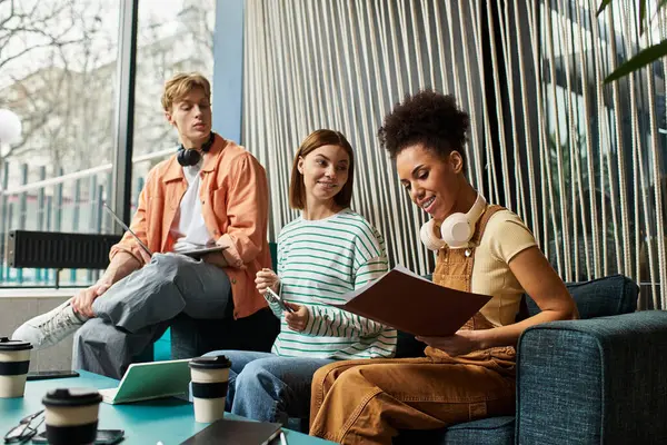 Three colleagues engage in discussions and planning while enjoying coffee at a hotel lounge. — Stock Photo
