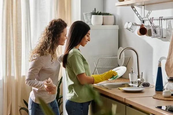Happy lesbian couple engage in daily chores together while enjoying their cozy apartment space. — Stock Photo
