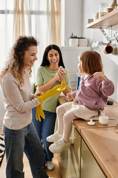 Two women and their daughter share joy and laughter during quality time at home. — Stock Photo