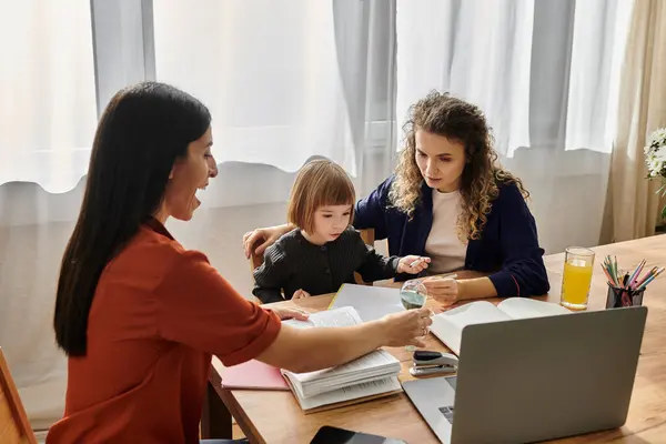 Two women engage lovingly with their daughter while enjoying a sunny afternoon at home. — Stock Photo
