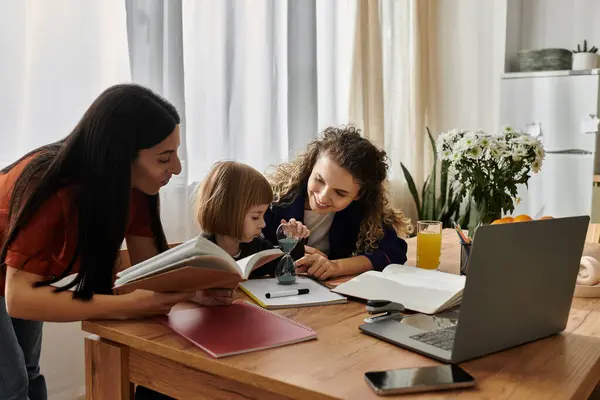 Two women and their daughter joyfully explore creativity together at home. — Stock Photo