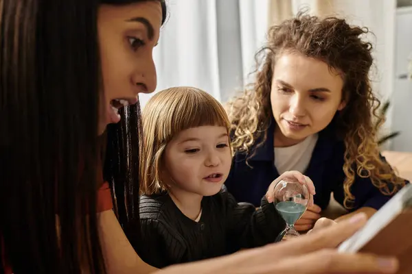 A loving family of three shares laughter while playing together in their stylish apartment. — Stock Photo