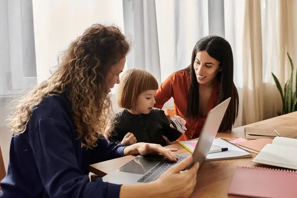 In a modern apartment, two women spend quality time with their daughter, exploring creativity. — Stock Photo