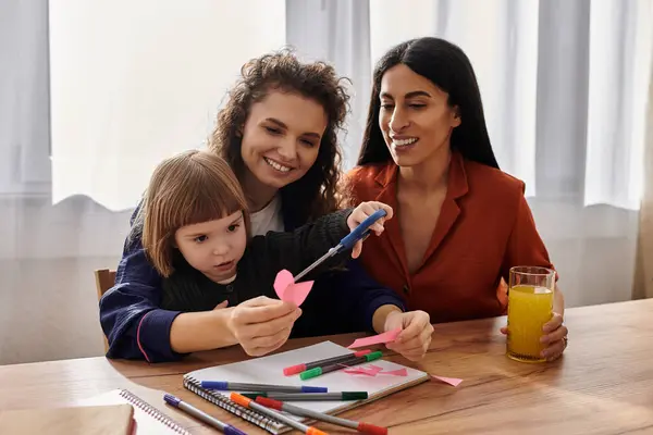 Two women actively engage in crafting with their daughter, filled with joy and creativity. — Stock Photo