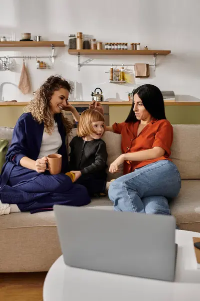 In a modern apartment, two women share laughter and warm moments with their daughter. — Stock Photo