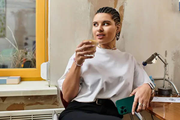 In a stylish cafe, a young woman relaxes while sipping her drink and enjoying the moment. — Stock Photo