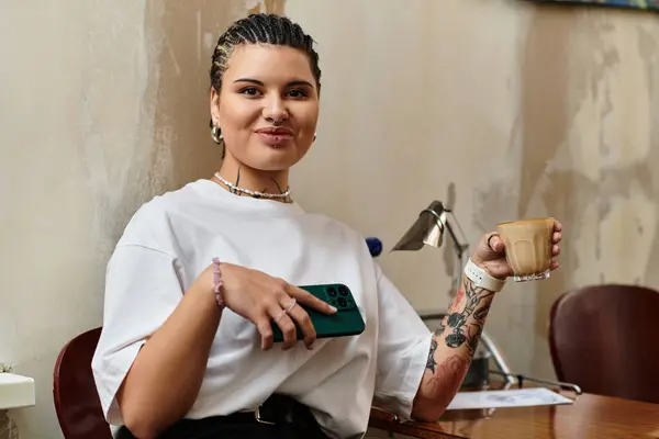 A young woman relaxes in a cafe, sipping coffee and showing off her unique style. — Stock Photo