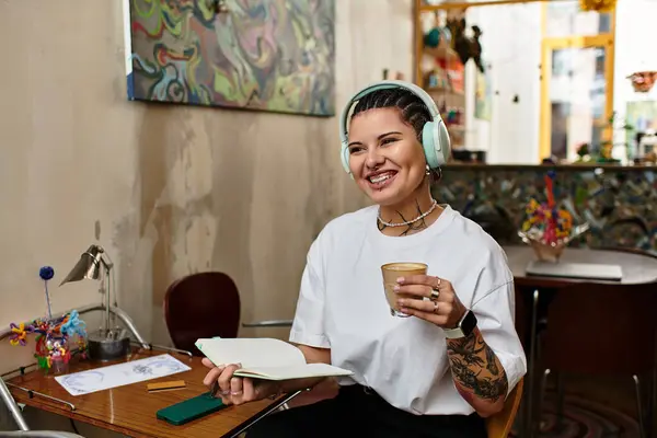 A young woman enjoys a moment of inspiration while sipping coffee in a lively cafe. — Stock Photo
