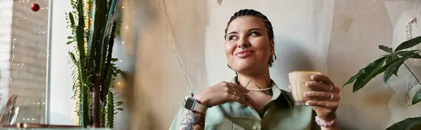 Молодая женщина с ярким характером расслабляется в кафе, наслаждаясь своим напитком, улыбаясь. — стоковое фото