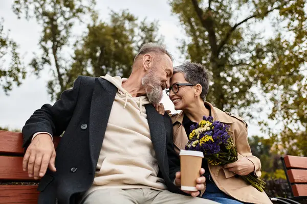 A loving couple enjoys a cozy moment together, sharing laughter and affection in the park. — Fotografia de Stock