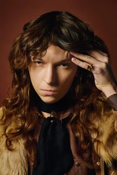 A handsome young man with flowing hair presents a striking look, emanating confidence and style. — Stock Photo