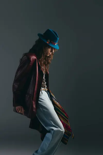 A stylish young man stands confidently, showcasing his unique fashion in a creative studio. — Stock Photo