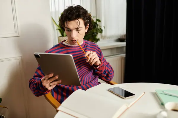 A young non binary individual relaxes in their modern apartment, focused on studying. — Stock Photo