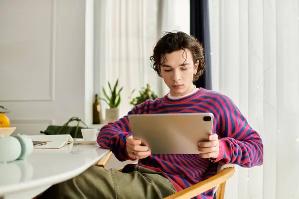 In a modern apartment, a non binary individual explores creativity with a tablet. — Stock Photo