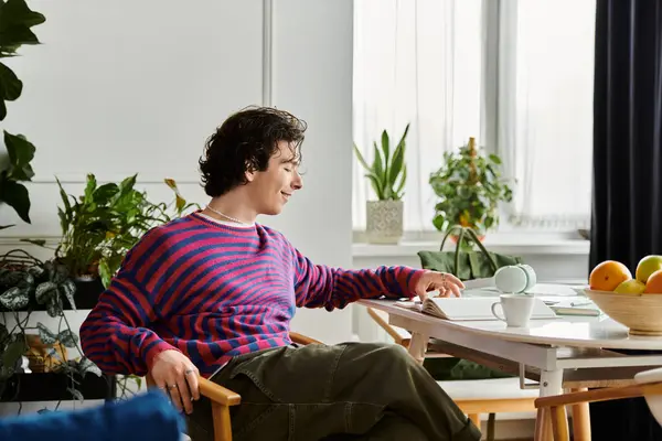 A non binary person enjoys a quiet moment, exploring ideas in a cozy and colorful space. — Stock Photo