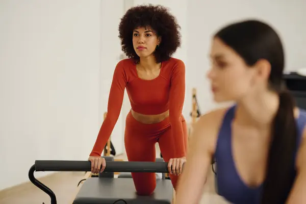 Two people committed to their Pilates workout, emphasizing strength and flexibility. — Stock Photo