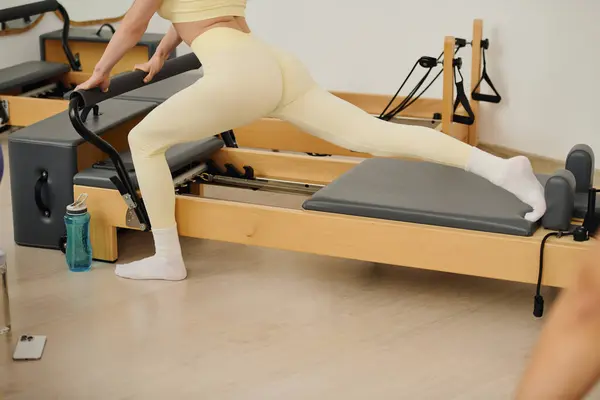 Practitioners use specialized equipment in a pilates session to boost core strength. — Stock Photo