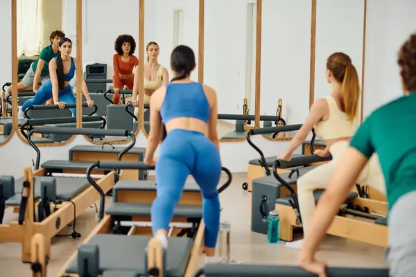 Participants engage in an interactive Pilates session, showcasing athleticism and teamwork. — Stock Photo