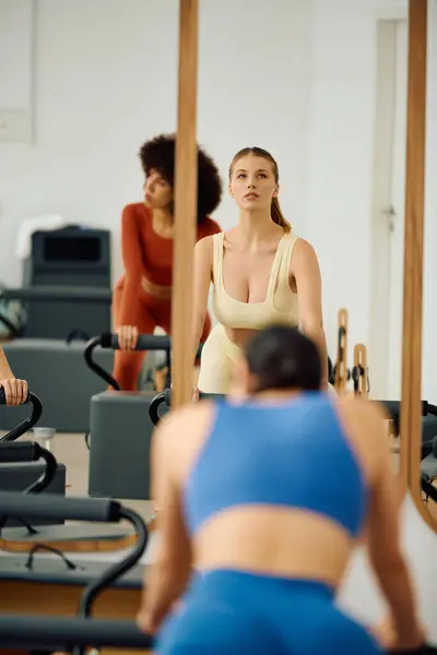 Passionate people demonstrate focus and strength in their engaging pilates class. — Stock Photo