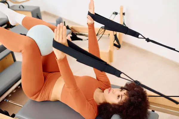 Pilates with equipment boosts core strength and flexibility in a serene studio. — Stock Photo
