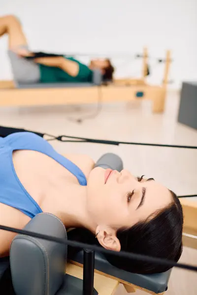 Participants practice pilates techniques, improving strength and posture in a serene environment. — Stock Photo