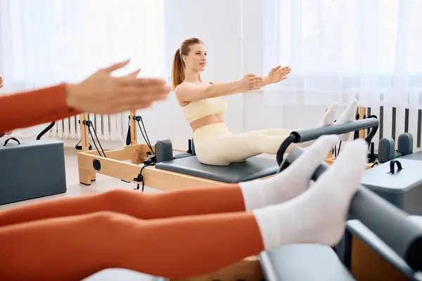 Two individuals practice pilates with focus and athleticism in a serene studio. — Stock Photo