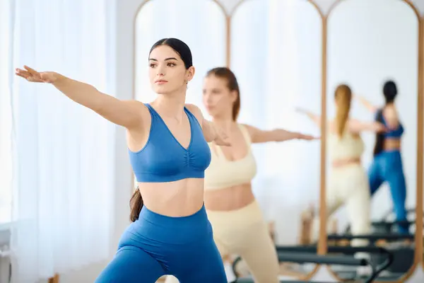 Two people practice pilates, showcasing strength and focus in a calm setting. — Stock Photo