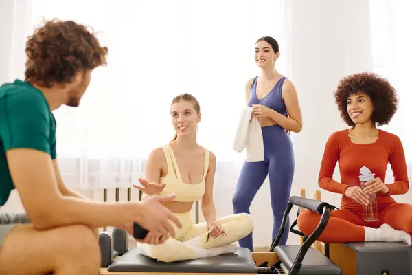 After an energizing workout, a group engages in lively conversation and relaxation in the studio. — Stock Photo