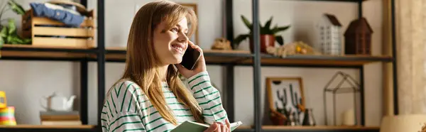 A pretty young woman smiling while sorting clothes to donate, promoting a sustainable lifestyle, banner — Stock Photo