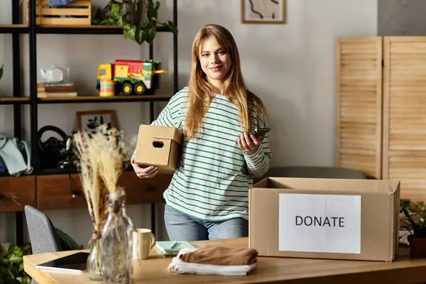 A young woman organizes her clothes and prepares to donate them, promoting sustainability. — Stock Photo