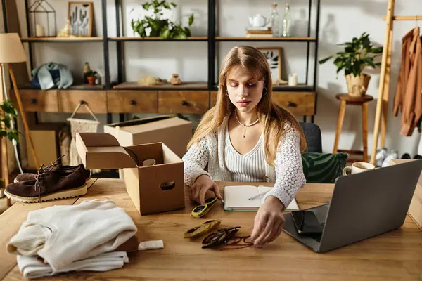 A young woman thoughtfully sorts her clothes to donate, showing her commitment to sustainability. — Stock Photo
