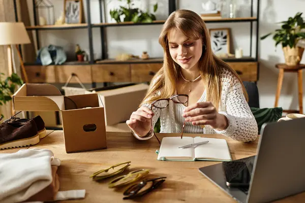 Pretty young woman sorts clothes for donation, embracing a sustainable lifestyle at home. — Stock Photo