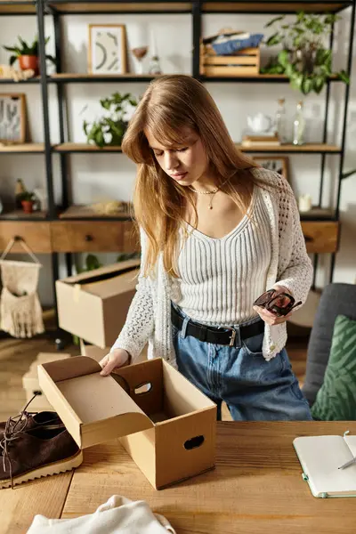 Mulher bonita organiza suas roupas para reciclagem e doação para promover a sustentabilidade. — Fotografia de Stock