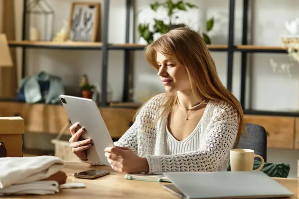 Pretty young woman sorts her clothes and using tablet at home, promoting a sustainable lifestyle and mindful living. — Stock Photo