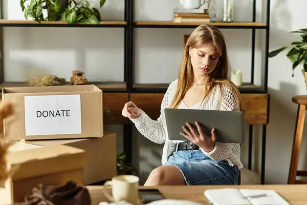 A young woman sorts through her clothes in a cozy space, preparing items for donation. — Stock Photo